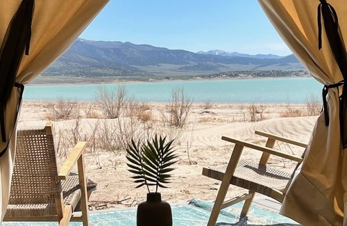 Levan House | Beautiful wall tent on sandy beach at waters edge