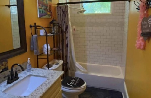 Treme House | bedroom and en suite bath in historic New Orleans home with pool & WiFi