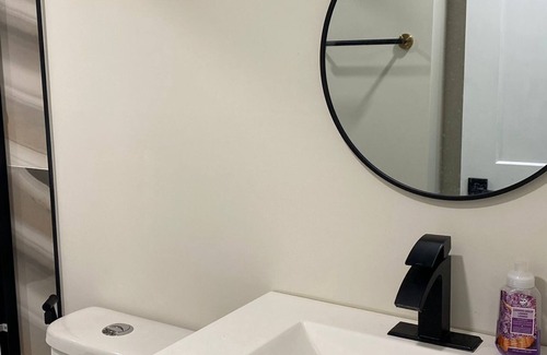 Southeast Calgary House | Bedroom with attached bathroom and dry bar