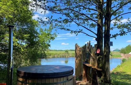 Washford Cabin | Bell tent in ultimate luxury with a wood fired hot tub, super king size bed
