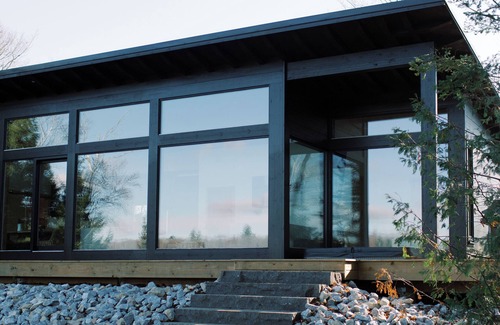 North Frontenac Cottage | Bellevue: A cozy, Scandinavian-style cottage nestled on a hill.