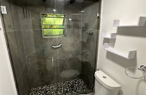 Hialeah House | Big room with queen bed, desk and private restroom.