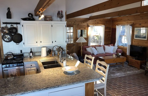 Suttons Bay House | Big Sandy Beach !Walk to Village! Suttons Bay Waterfront Cottage.