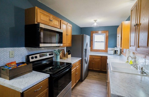 Woodward House | Blue house on 5th! Arcade room, fire pit, privacy fenced yard, and more!