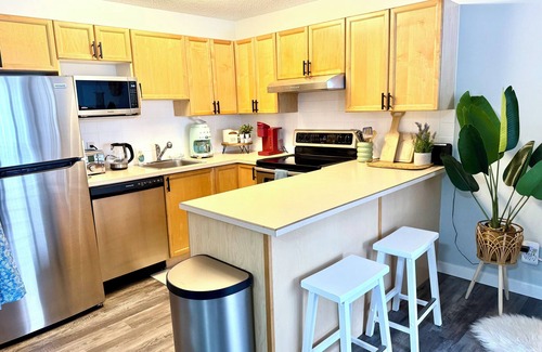 East Kootenay Condo | Boho theme, Ground floor patio with green space and creek view. 2 min to gondola
