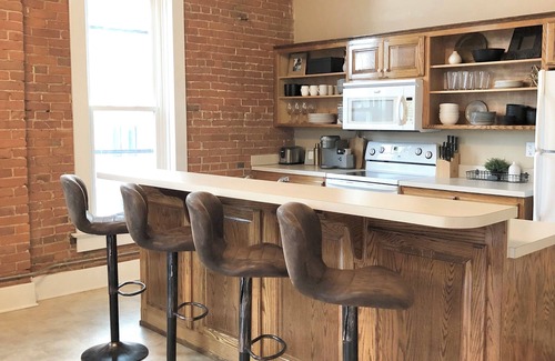 Paola Apartment | Bright and Spacious Historic Brick Loft off the square in Paola