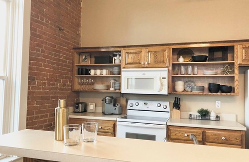 Paola Apartment | Bright and Spacious Historic Brick Loft off the square in Paola