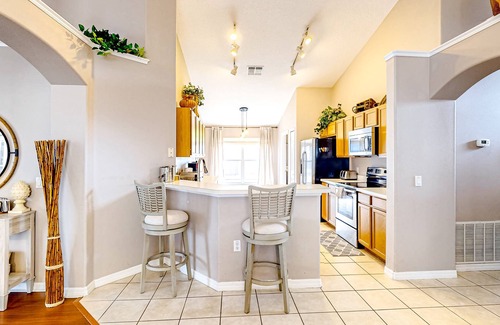 Eagle Pointe South House | Bright home with an enclosed pool, patio, Ping-Pong table, foosball, and AC
