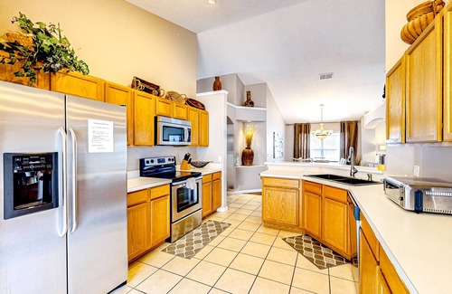 Eagle Pointe South House | Bright home with an enclosed pool, patio, Ping-Pong table, foosball, and AC
