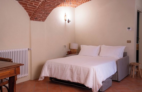 Lessona Bed & Breakfast | Bruno Selvago's Casba. Rustic house with exposed brick surrounded by vineyards.
