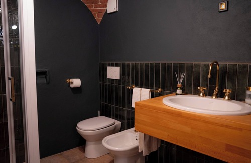 Lessona Bed & Breakfast | Bruno Selvago's Casba. Rustic house with exposed brick surrounded by vineyards.