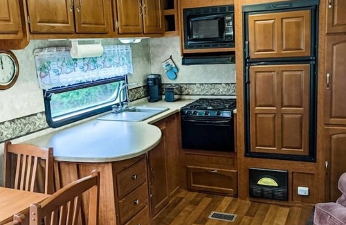 Burks Fork Cabin | Camper in middle of farm setting with creek view