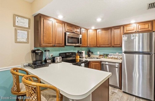 Port Canaveral Condo | Cape Canaveral Oceanside Oasis - 1st floor with bikes and beach toys
