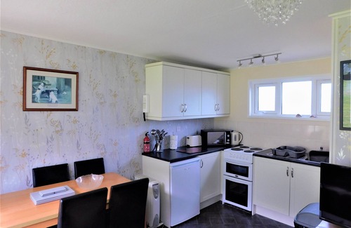 Cromer Ski Chalet | Chalet with open planned kitchen/living area, benefiting from direct access to fantastic cliff walks