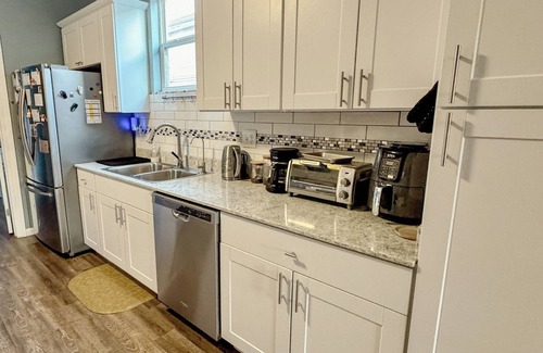Florida Area House | Charming Blue Retreat with home gym, EV hookups, king bed, and more