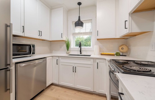 Blacksburg House | Charming cottage entrance with cozy curb appeal, nestled in a peaceful and green setting.