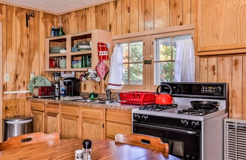 Three Lakes House | Charming, dog-friendly, lakefront cottage with boat dock, grill, & firepit