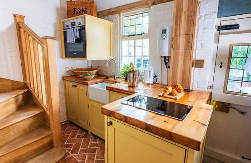 Ipswich Cottage | Charming medieval cottage courtyard garden and wood burner in serene Kersey