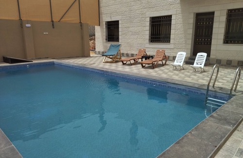 Madaba Villa | Cheerful two bedrooms villa with warm pool, playground,& specious sitting room.