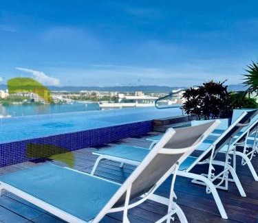 North Hotel Zone Apartment | Chic 1BR 1BA Zoho Skies condo with rooftop pool stunning views