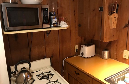 Lake Ripley Cottage | Classic cabin/cottage with big screen porch, stone fireplace, knotty pine walls.