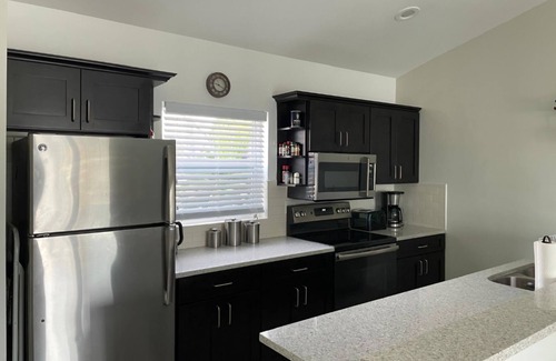 Wheeland Settlement Condo | “Coastal Bliss: Stunning 2-Bedroom Condo with breathtaking Beach and Pool Views”