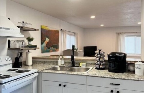 Rock Springs House | Completely Renovated home comfortably accommodates your stay with a queen bed in the primary bedroom, a twin bed with a pull-out trundle in the second bedroom, and a sleeper sofa in the living room for additional guests.