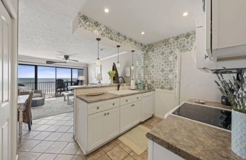 Wilmington Beach Condo | Conched Out - Feel the ocean breezes as you relax on the deck overlooking the lovely Carolina Beach coastline by RedAwning