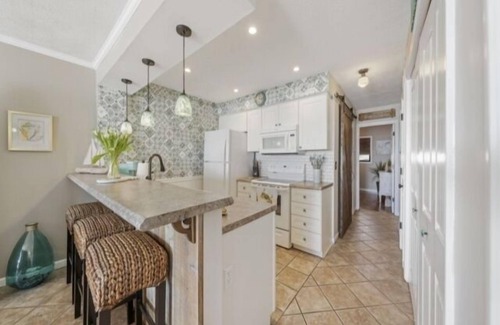 Wilmington Beach Condo | Conched Out - Feel the ocean breezes as you relax on the deck overlooking the lovely Carolina Beach coastline by RedAwning