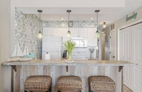 Wilmington Beach Condo | Conched Out - Feel the ocean breezes as you relax on the deck overlooking the lovely Carolina Beach coastline by RedAwning