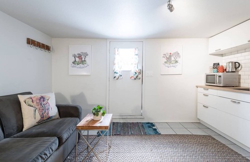 Kensington-Cedar Cottage House | Cool, cozy and modern space with a garden patio to enjoy meals in sunny weather.