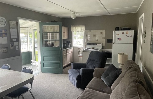 Ludington Cottage | Cottage 1 is a charming 2 bedroom only 25’ from its boat dock & Hamlin lake.