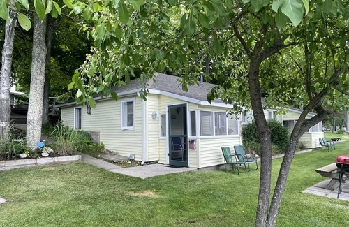 Ludington Cottage | Cottage 1 is a charming 2 bedroom only 25’ from its boat dock & Hamlin lake.