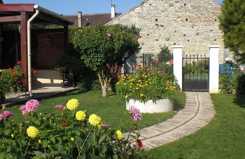 Tanlay Cottage | cottage commissey in a flower garden
