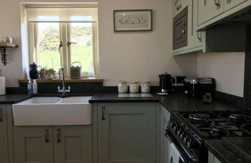 Graigfechan House | Countryside Home with jacuzzi hot tub, open plan living and wood burner.