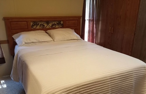 Manistique House | Cozy accommodations on Indian Lake with small sand beach.