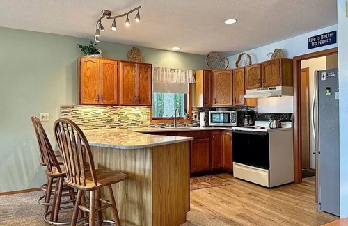 Elmira Cottage | Cozy beachfront cottage in the woods with walkout basement and wrap-around porch