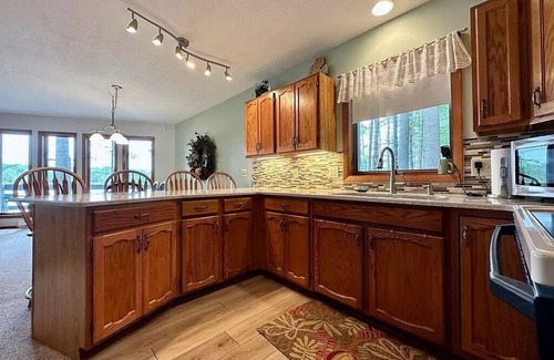 Elmira Cottage | Cozy beachfront cottage in the woods with walkout basement and wrap-around porch
