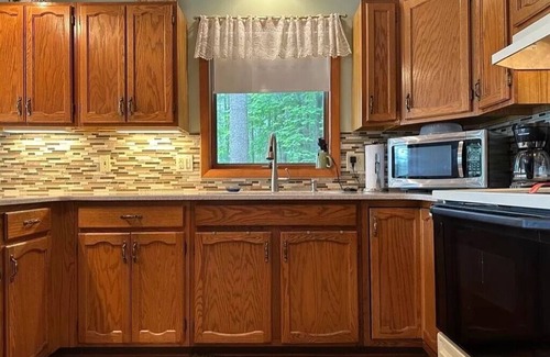 Elmira Cottage | Cozy beachfront cottage in the woods with walkout basement and wrap-around porch