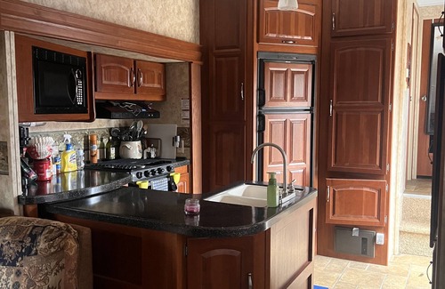 Charlotte House | Cozy camper trailer with great views of the sky. Fire pit great for entertaining