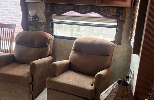 Charlotte House | Cozy camper trailer with great views of the sky. Fire pit great for entertaining