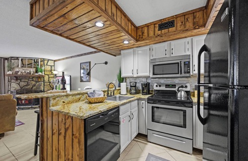 Chalet Village Condo | Cozy Condo with Wood-burning FP & Patio Gliders
