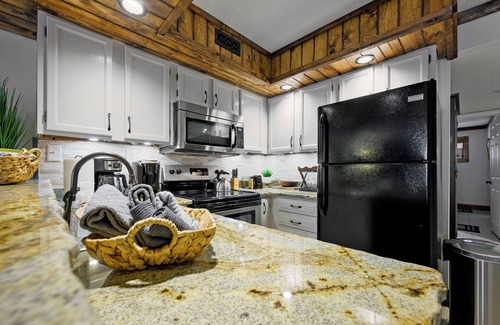 Chalet Village Condo | Cozy Condo with Wood-burning FP & Patio Gliders