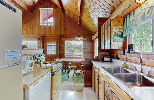 Rollins Cabin | Cozy lakefront log cabin with lake views, vintage decor, & dock
