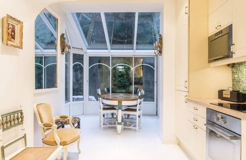 16th Arrondissement Apartment | Cozy Parisian style apartment with a veranda overlooking a private garden.