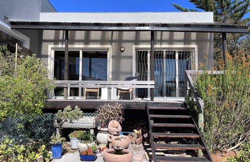 Kommetjie Apartment | Cozy Retreat: 1-Bedroom with stunning sea view down serene green belt."