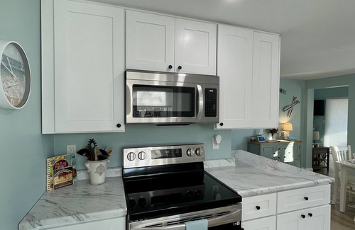 Oscoda Cottage | Cozy riverfront cottage with an easy beach-inspired coastal MI vibe!