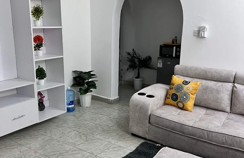 Mombasa Apartment | Cozy specious living room with a Tv for entertainment and free WiFi.