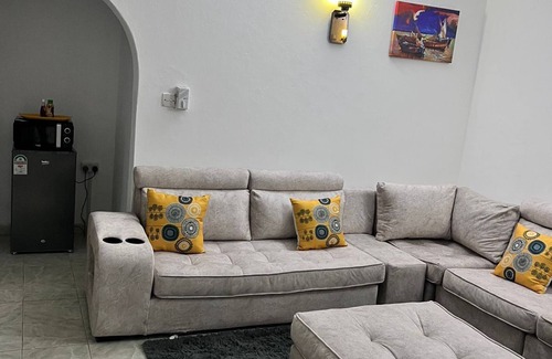 Mombasa Apartment | Cozy specious living room with a Tv for entertainment and free WiFi.