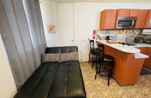 Bucana Apartment | Cozy Studio Retreat with Private Parking and Laundry. Pet Friendly